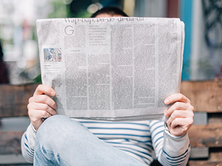 Person reading a newspaper